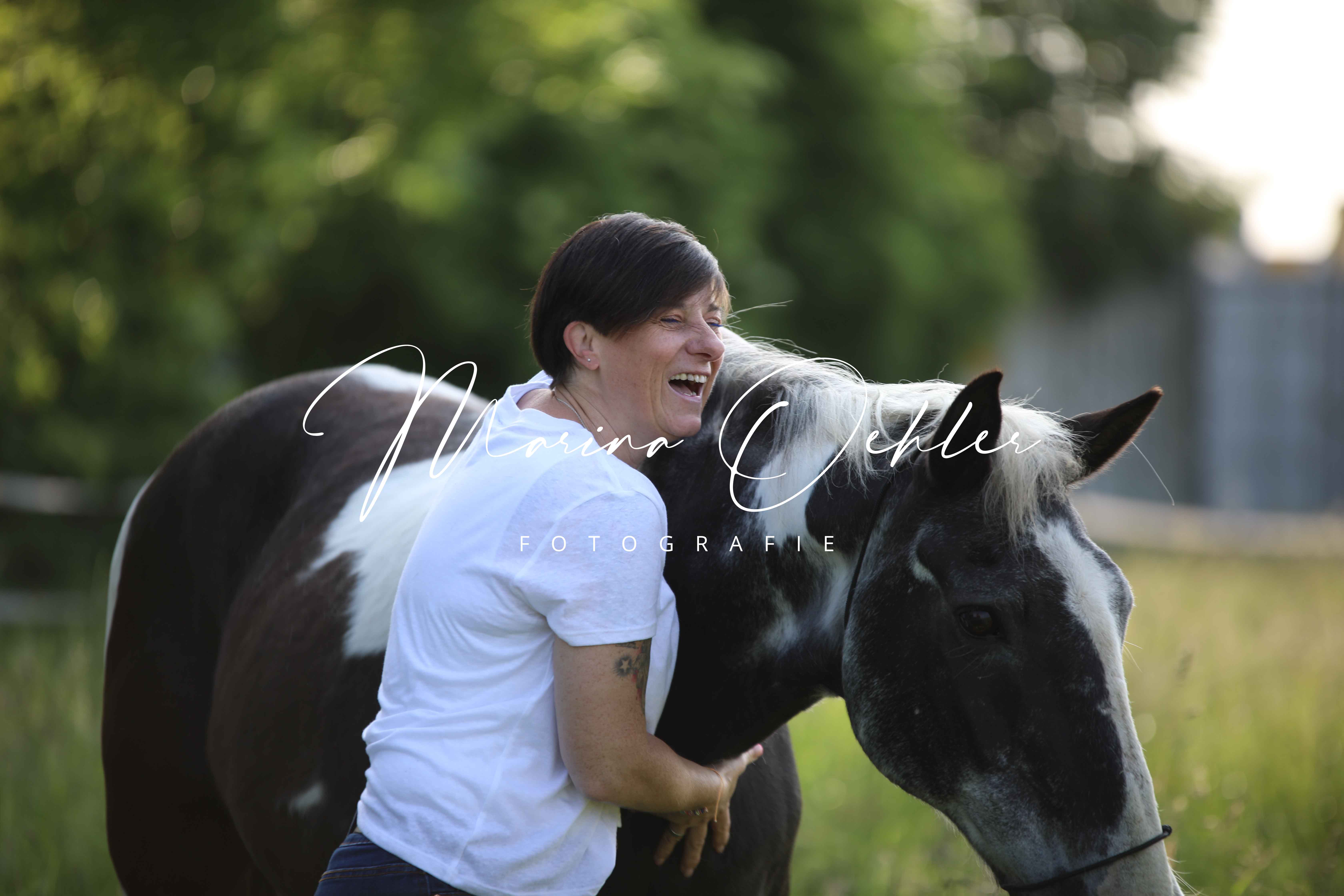 Yvonne mit ihrem Pferd auf der Koppel